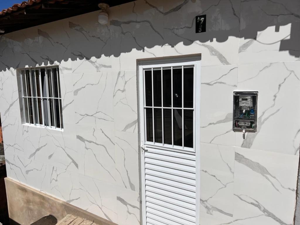 a white building with a door and two windows at Casa de Praia Maragoggi in Maragogi