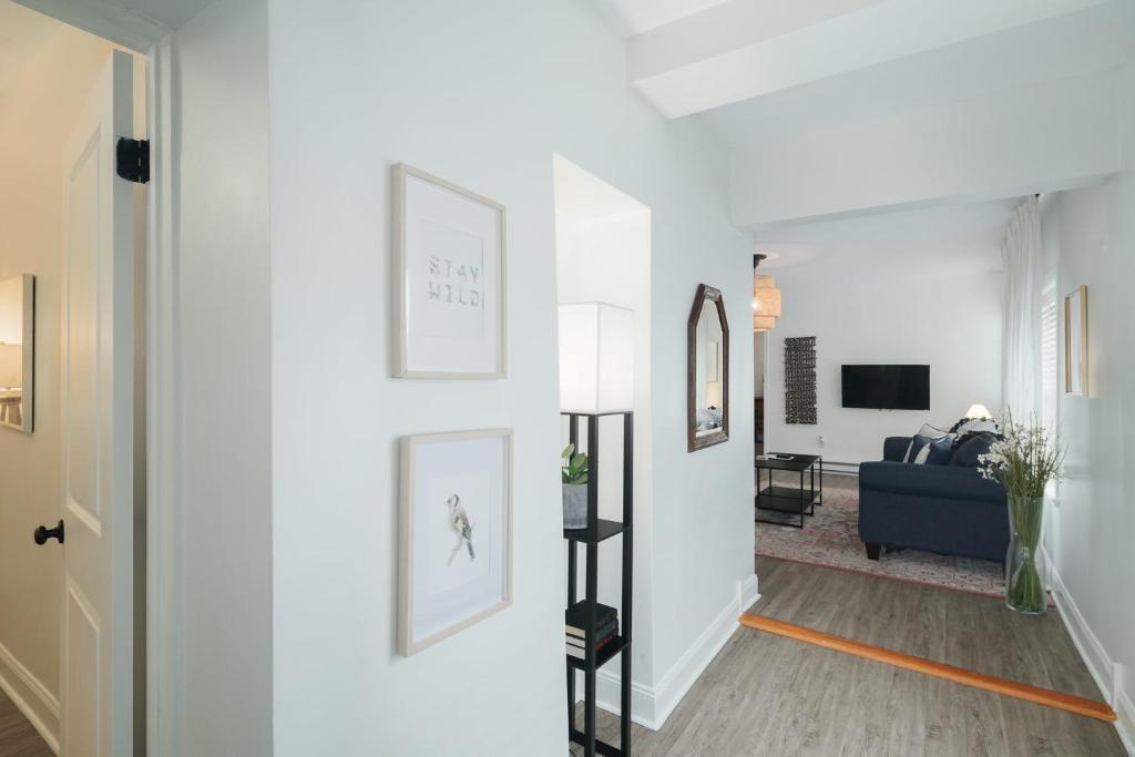 a hallway with white walls and a living room at Stroll to Main St: 2BR on the Park in Philadelphia