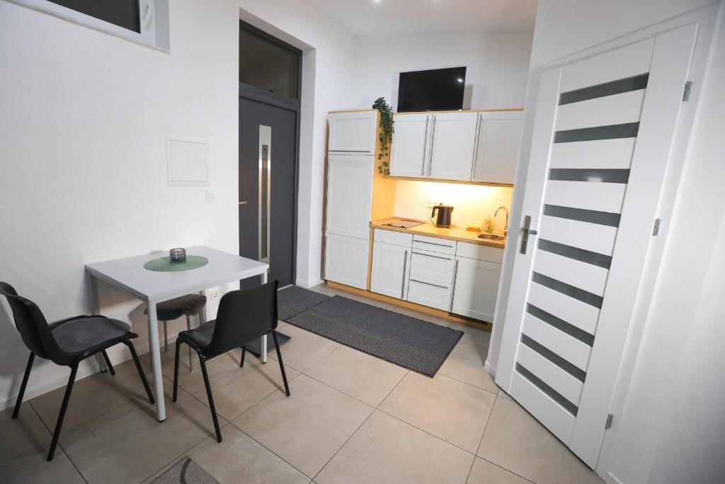 cocina con mesa y sillas en una habitación en Gemütliches Apartment in der Nähe von Köln, en Hürth