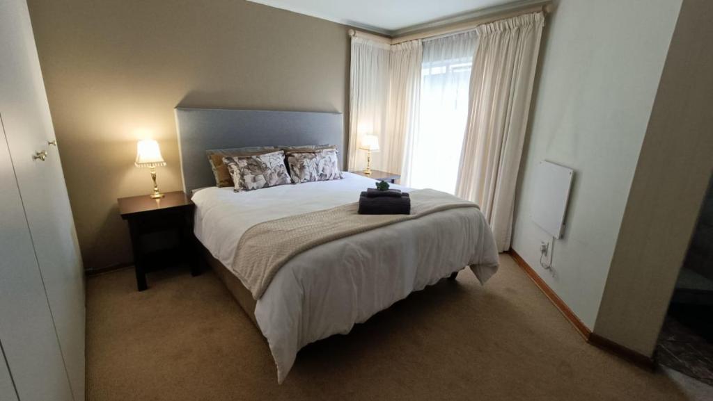 a bedroom with a large bed and a window at 741 Tetra Self Catering Accommodation in Pretoria