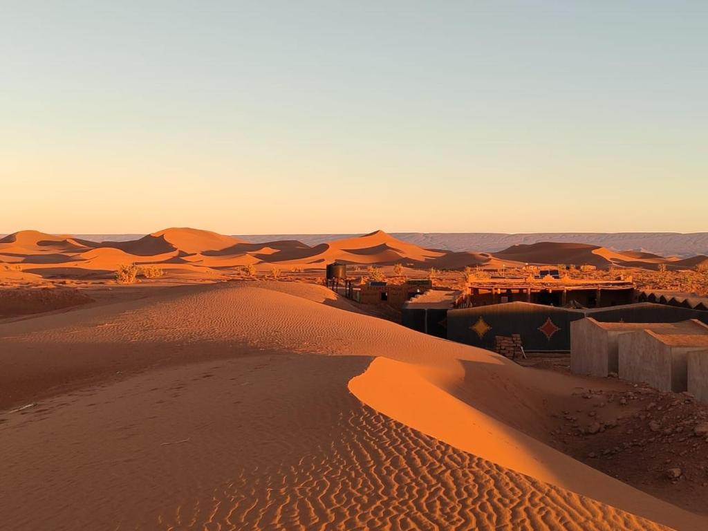 an aerial view of a desert with sand dunes at Chegaga Luxury Camp in El Gouera