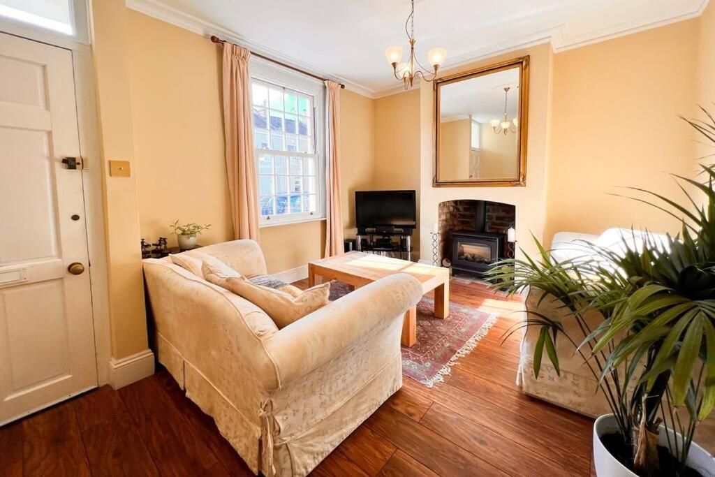 a living room with a couch and a table at Two Bedroom Period Property in Tivoli Cheltenham in Cheltenham
