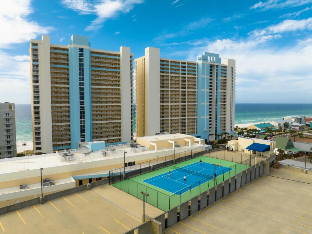 an aerial view of a resort with a tennis court at Majestic Beach Resort, Panama City Beach, Fl in Panama City Beach