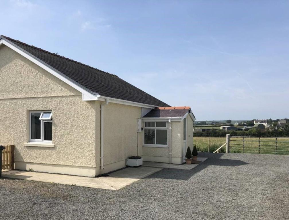 a small white house with a field behind it at The Annexe - Spacious 2 bedroom detached cottage in Cardigan