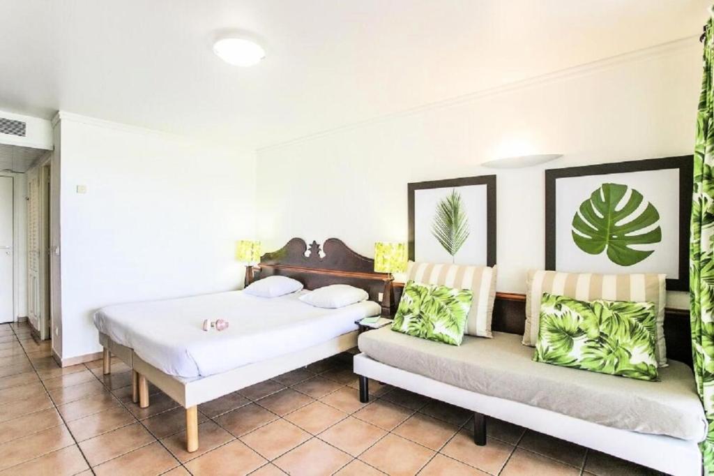 a bedroom with two beds and two chairs at Village Sainte Luce, Martinique - maeva Home - Studio 3 personnes - Prestige MAE-2804 in Sainte-Luce
