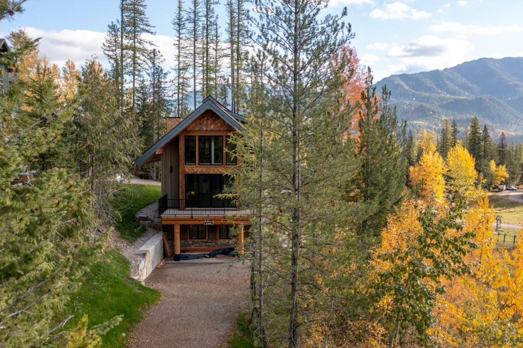 a house in the middle of a forest at Snow Creek Cabins by Fernie Lodging Co in Fernie