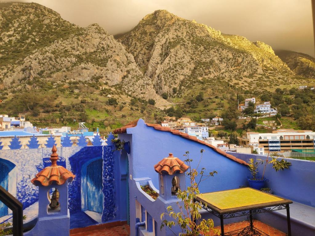 a view of the mountains from the balcony of a house at Blue city Chefchaouen in Chefchaouen