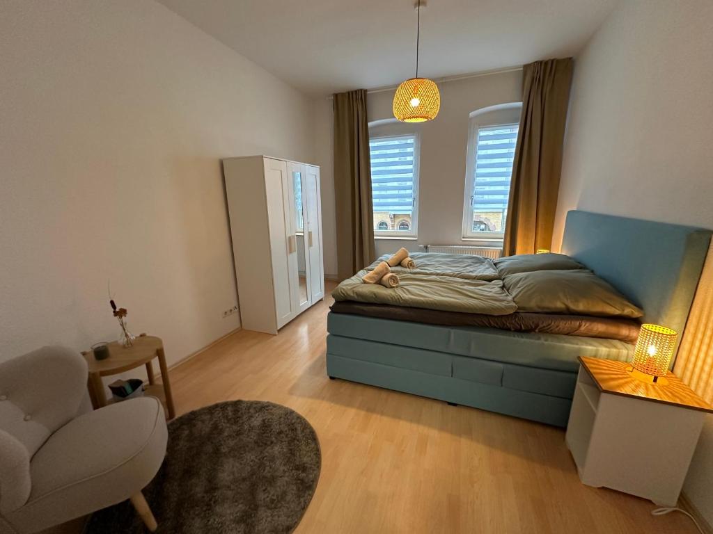 a small bedroom with a bed and a chair at Ferienwohnung für 8 mit Balkon in Erfurt