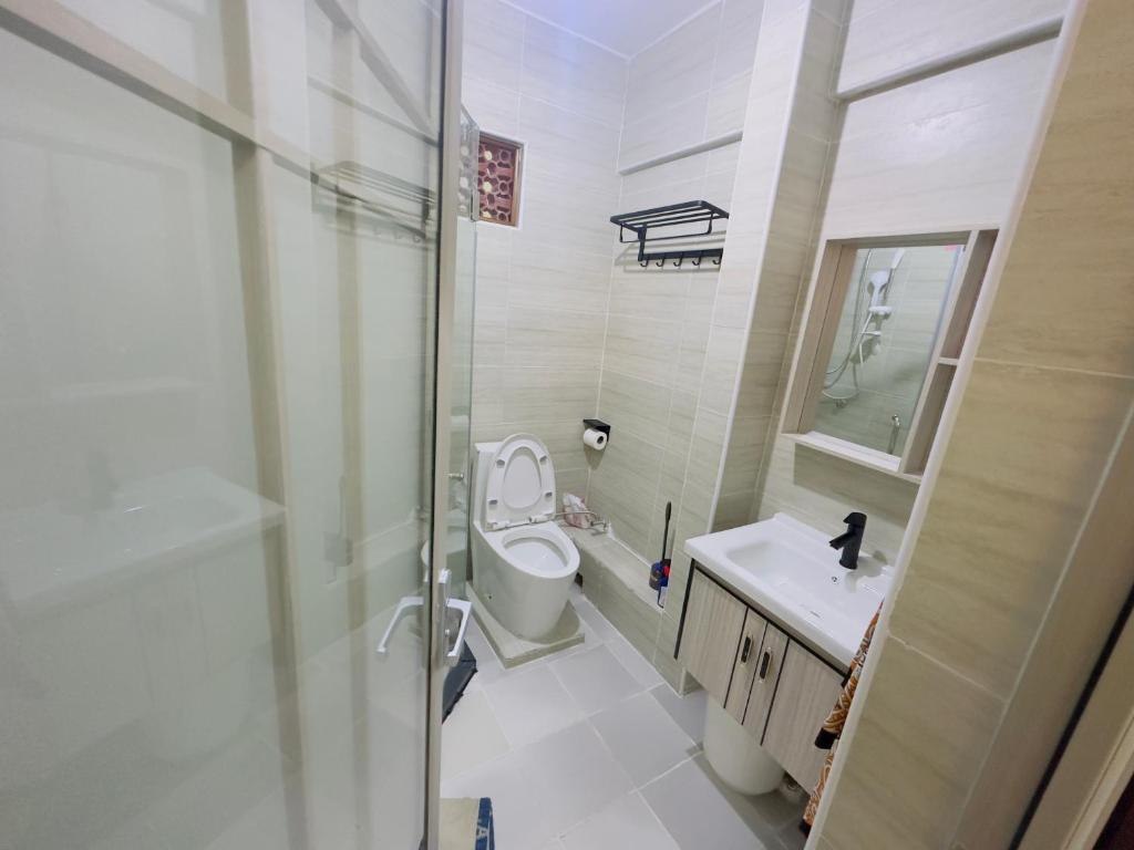 a bathroom with a toilet and a sink and a shower at HOBAK STAYS in Nairobi