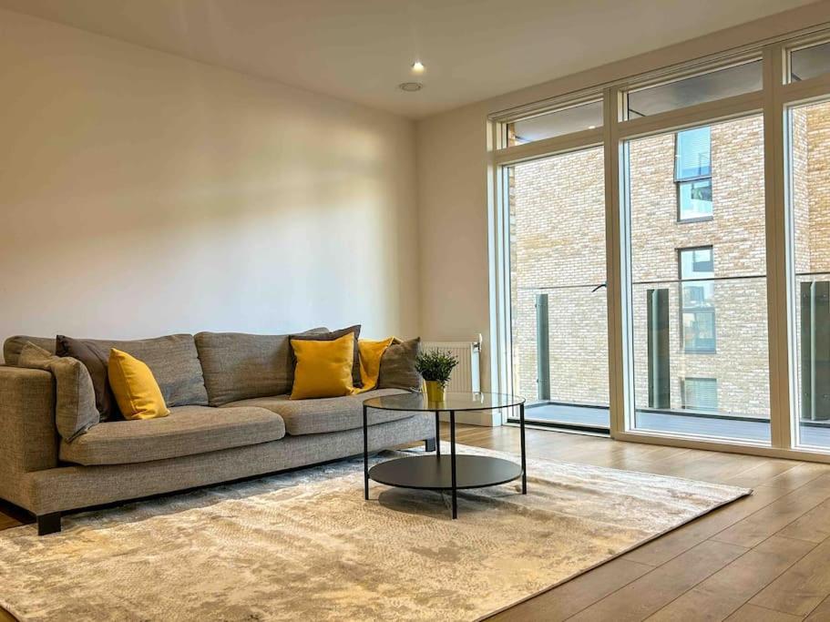 a living room with a couch and a table at Stunning two bedroom apartment in London