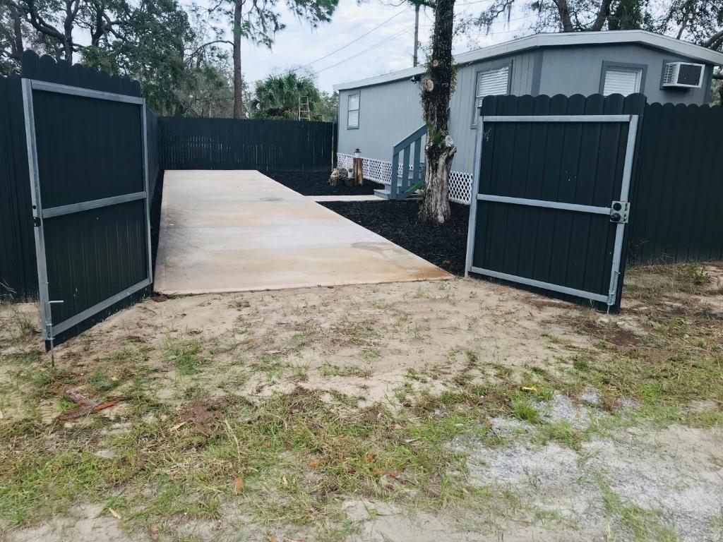 an open gate in a yard with a fence at 10515 Houston Avenue in Hudson