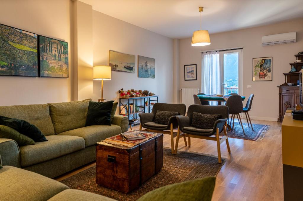 a living room with a couch and a table at La Paperella Blu Apartment in Termini Imerese