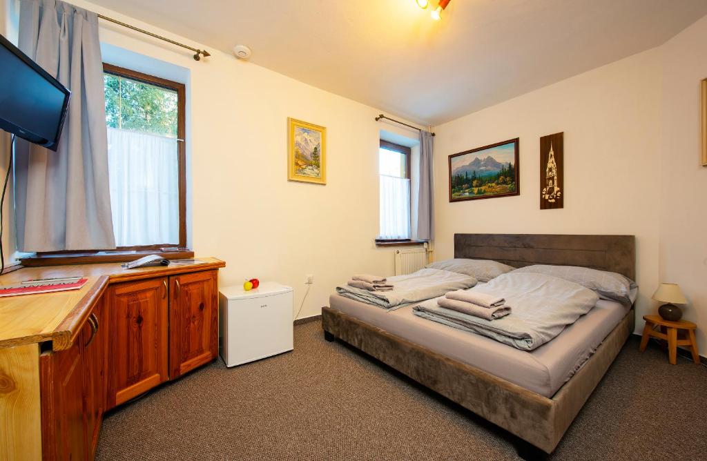 A bed or beds in a room at Wellness Vila Astra