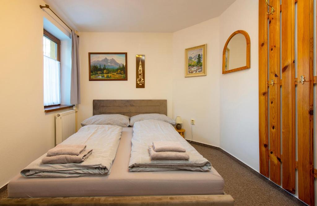 A bed or beds in a room at Wellness Vila Astra