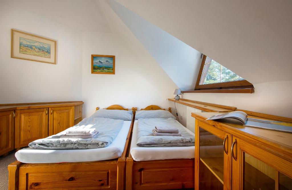 A bed or beds in a room at Wellness Vila Astra