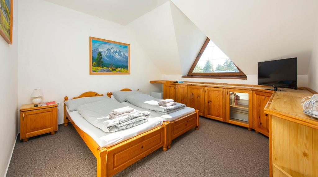 A bed or beds in a room at Wellness Vila Astra