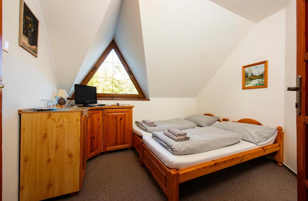 A bed or beds in a room at Wellness Vila Astra