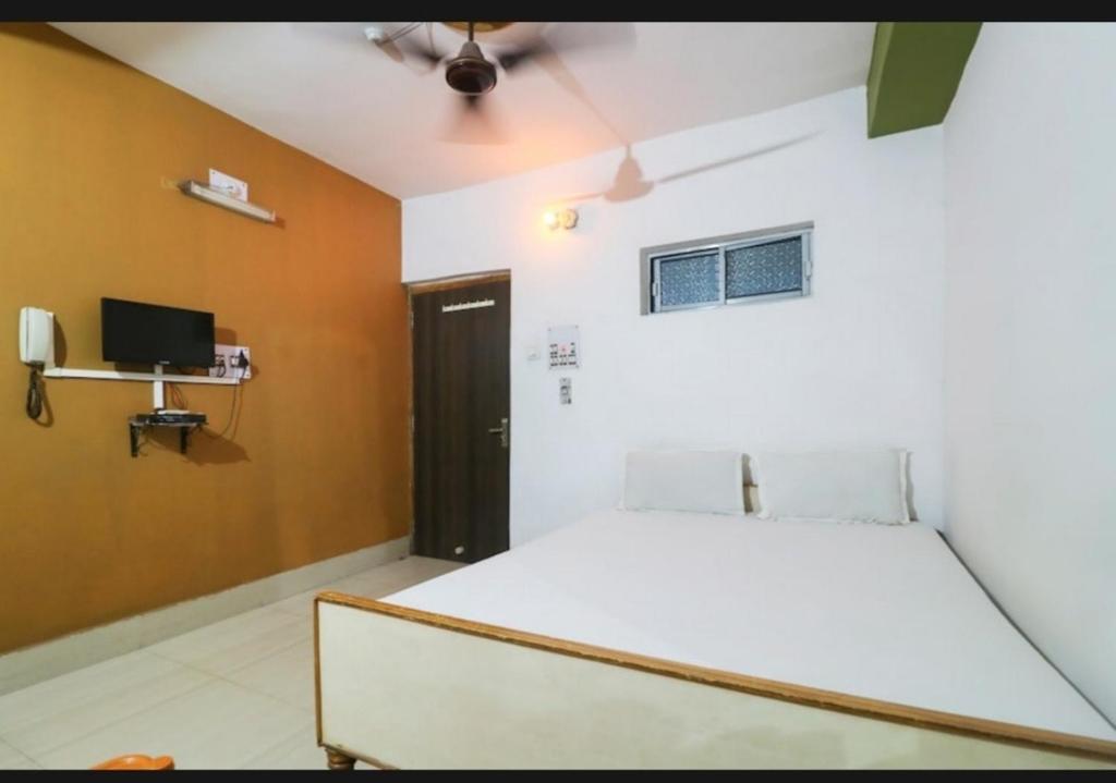 a bedroom with a bed and a television in it at Hotel Nilay And Banquet (Vivaah Palace) in Kahalgaon