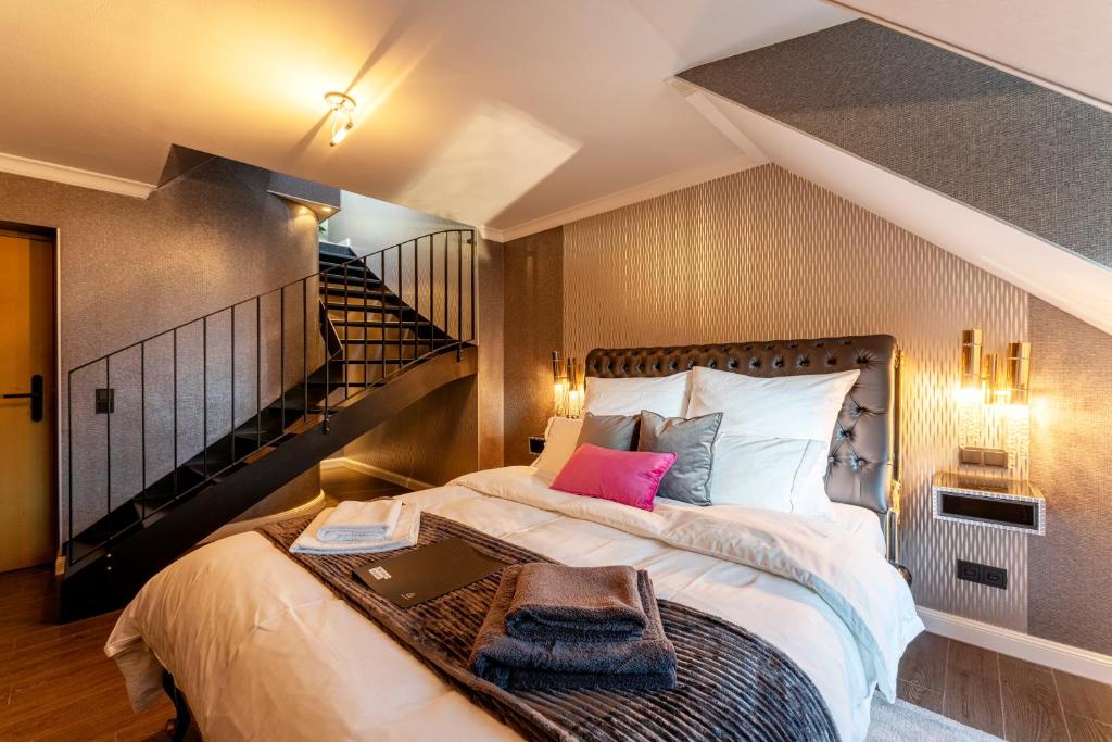 a bedroom with a large bed with a laptop on it at La Belle 10 in Cologne