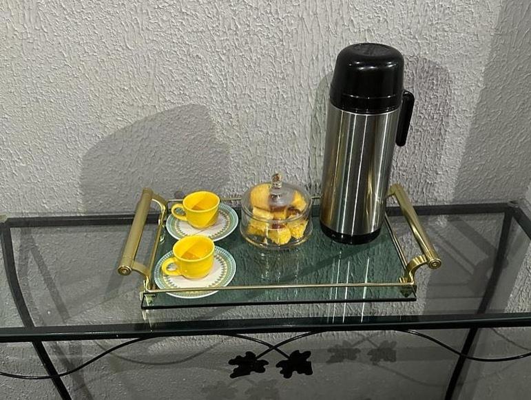 a glass table with two cups and a coffee maker at Pousada da Onça - Itapiranga, AM in Itapiranga
