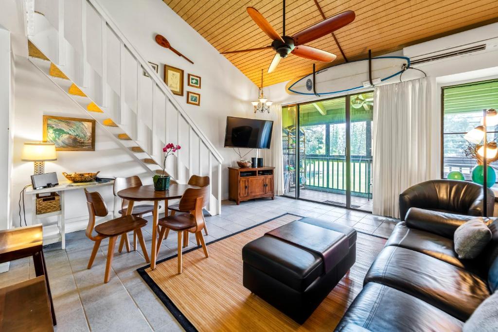 a living room with a couch and a table at Turtle Bay Townhouse Steps to Our Beautiful Beach! in Kahuku