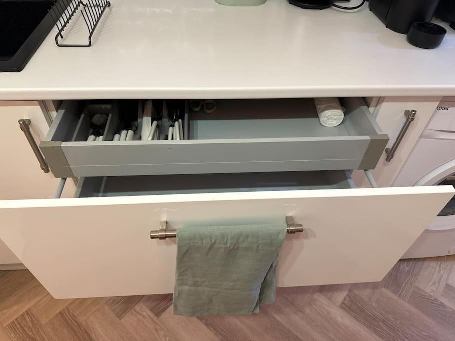 a white desk with a towel hanging from a drawer at The Studio at Athol House in London