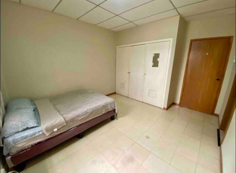 a bedroom with a bed and a closet in it at Private Room in Urdesa Central Guayaquil in Guayaquil