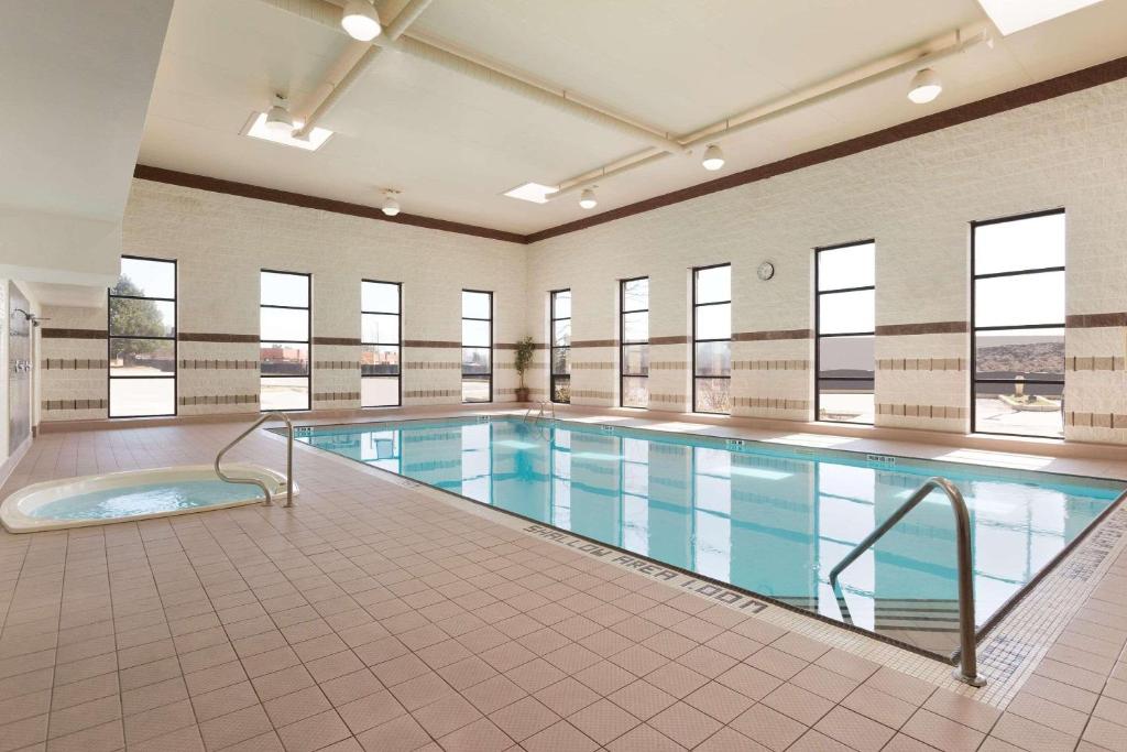a large swimming pool in a building with windows at Park Inn by Radisson Toronto-Markham in Markham