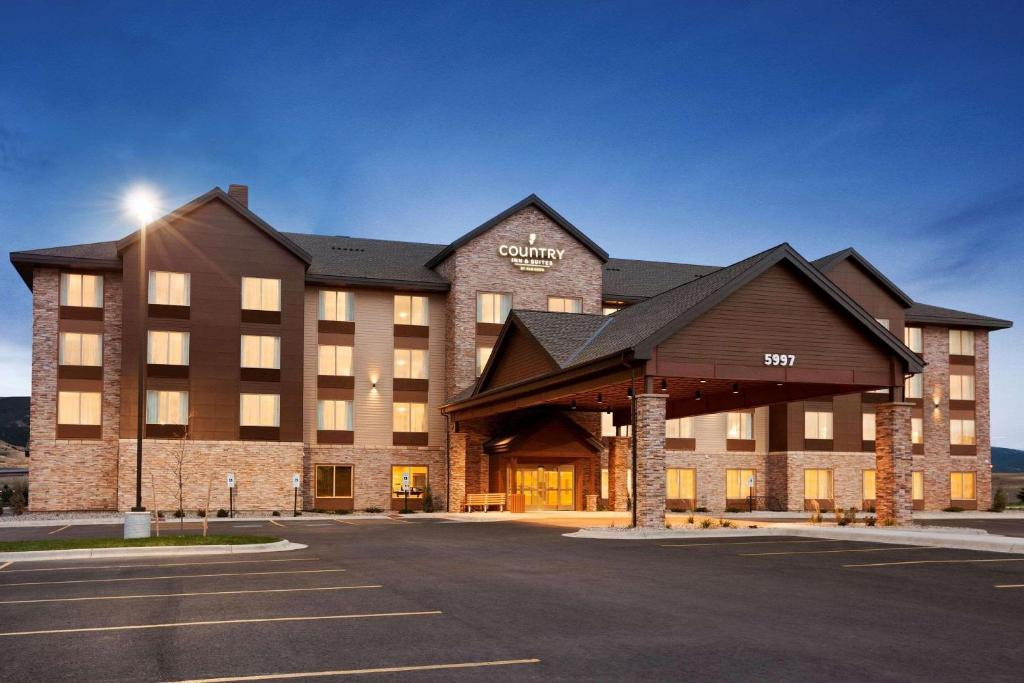 a large building with a parking lot in front of it at Country Inn & Suites by Radisson, Bozeman, MT in Bozeman