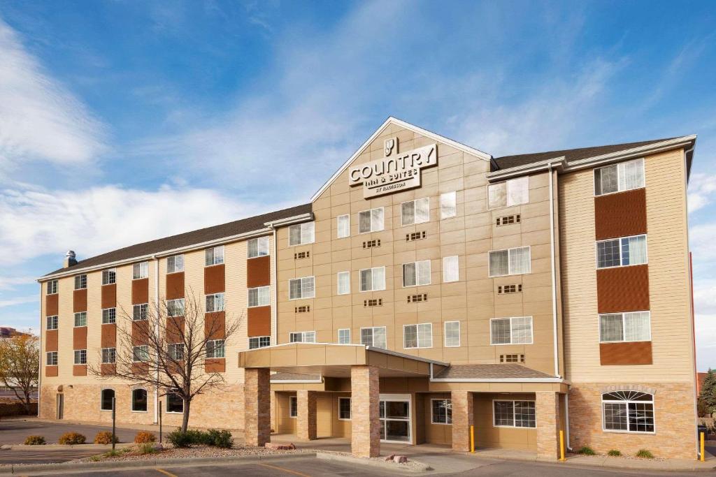 a building with a dutton hotel sign on it at Country Inn & Suites by Radisson, Sioux Falls, SD in Sioux Falls