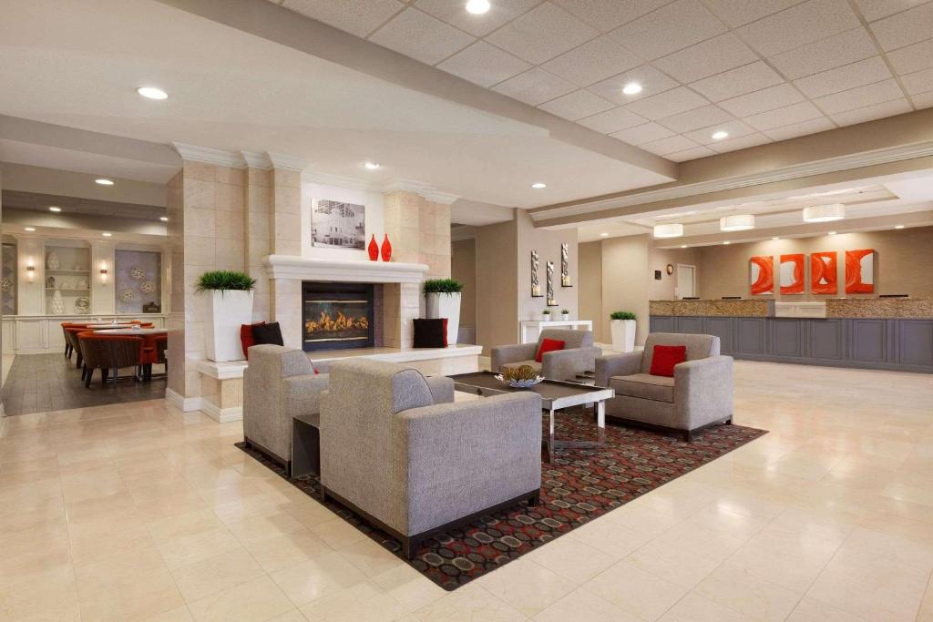 a lobby with couches and a fireplace in a hospital at Radisson Hotel Phoenix Airport in Phoenix
