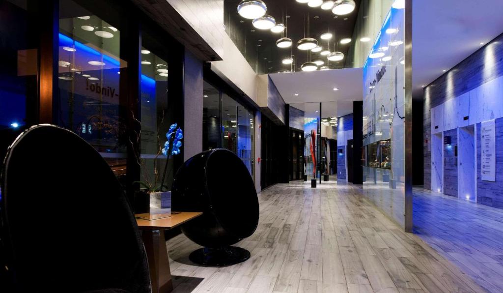 a hallway of a store with a table and chairs at Radisson Blu Belo Horizonte Savassi in Belo Horizonte