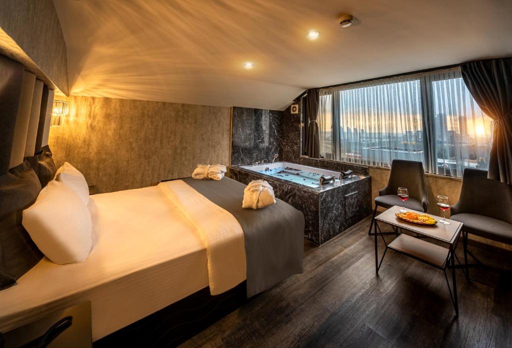 a hotel room with a bed and a tub at Golden Dream Otel in Istanbul