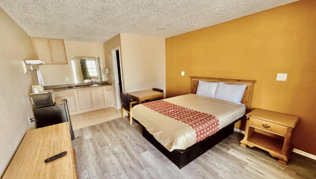 a small room with a bed and a kitchen at Regency Inn Hondo in Hondo