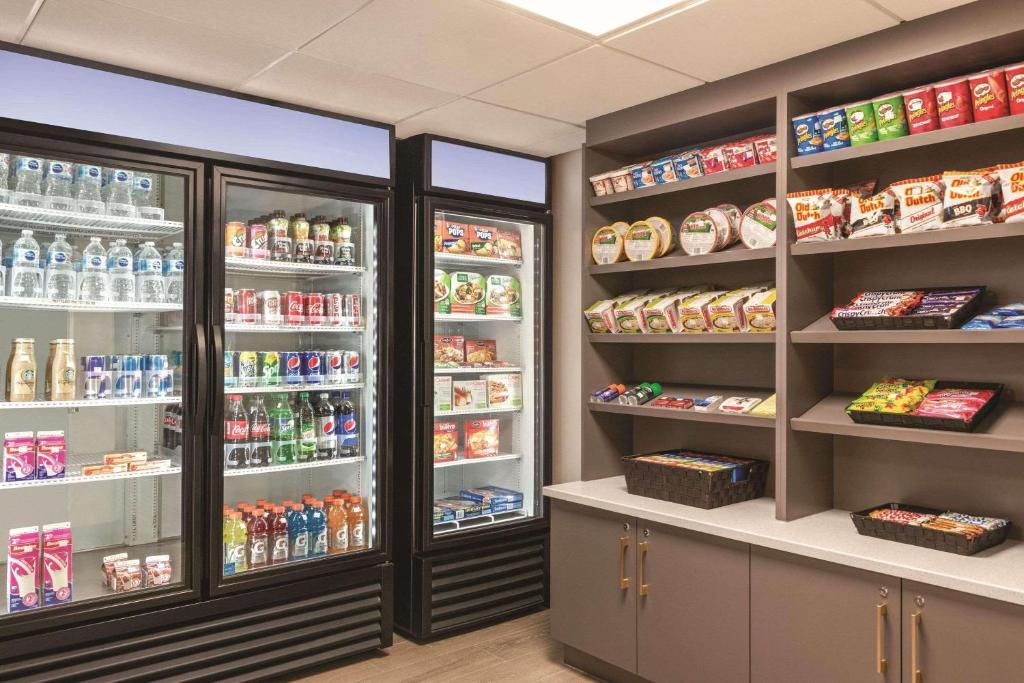 a store refrigerator with lots of food and drinks at Park Inn by Radisson, Calgary Airport North, AB in Calgary