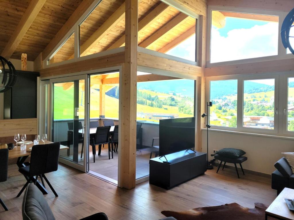 a large living room with a large glass window at Grebenzen Lodge Prinz in Sankt Lambrecht