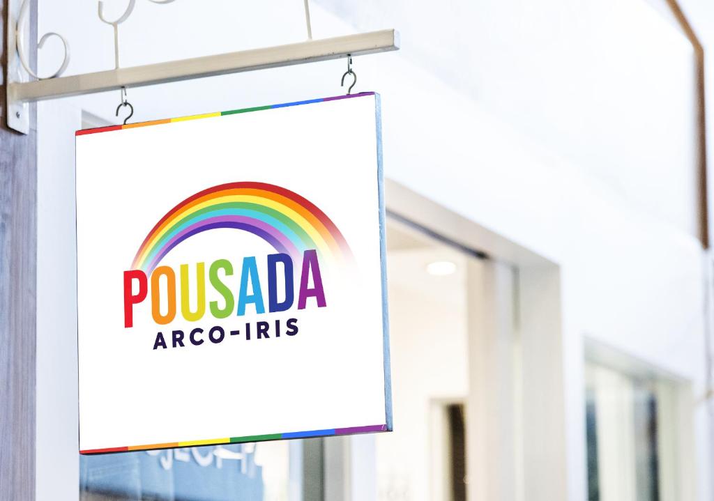 a sign for a pixada argos inc store at Pousada Arco-Íris in Lambari