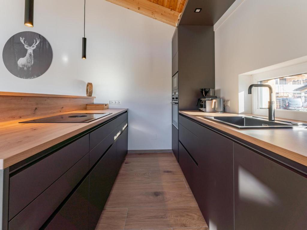 a kitchen with wooden counter tops and a sink at Grebenzen Lodge Prinz in Sankt Lambrecht