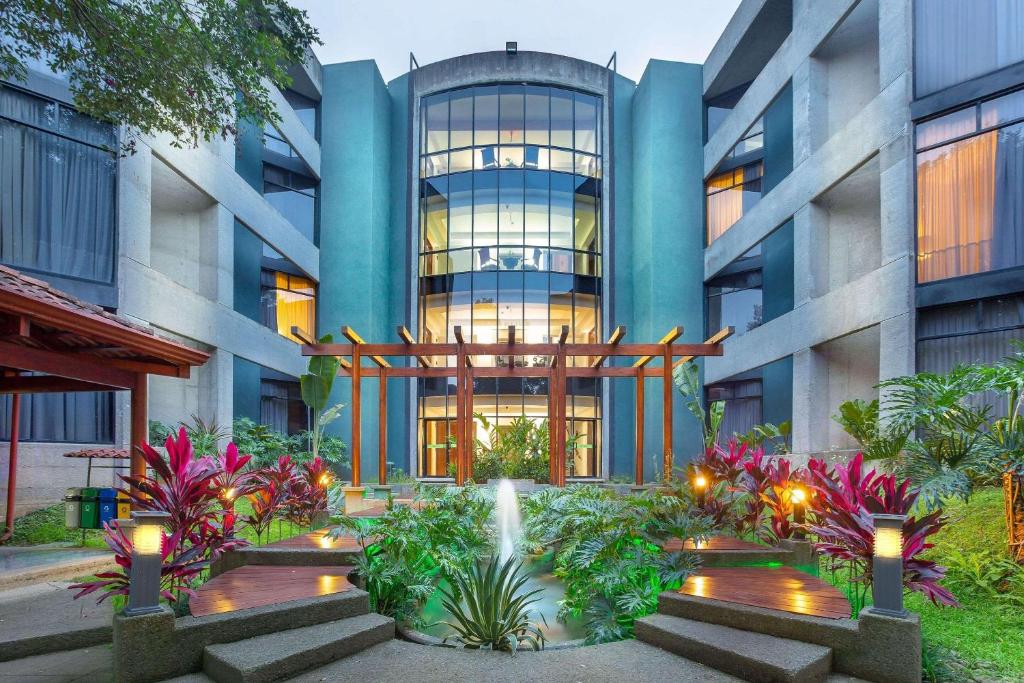 a building with a fountain in front of it at Radisson San Jose-Costa Rica in San José