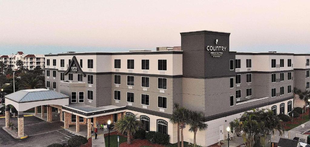 a rendering of a hotel with a sign on it at Country Inn & Suites by Radisson, Port Canaveral, FL in Cape Canaveral