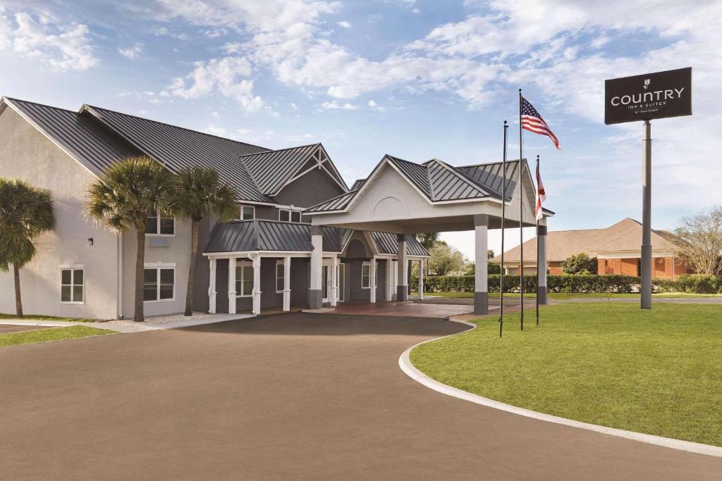 a building with an american flag in front of it at Country Inn & Suites by Radisson, Panama City, FL in Panama City