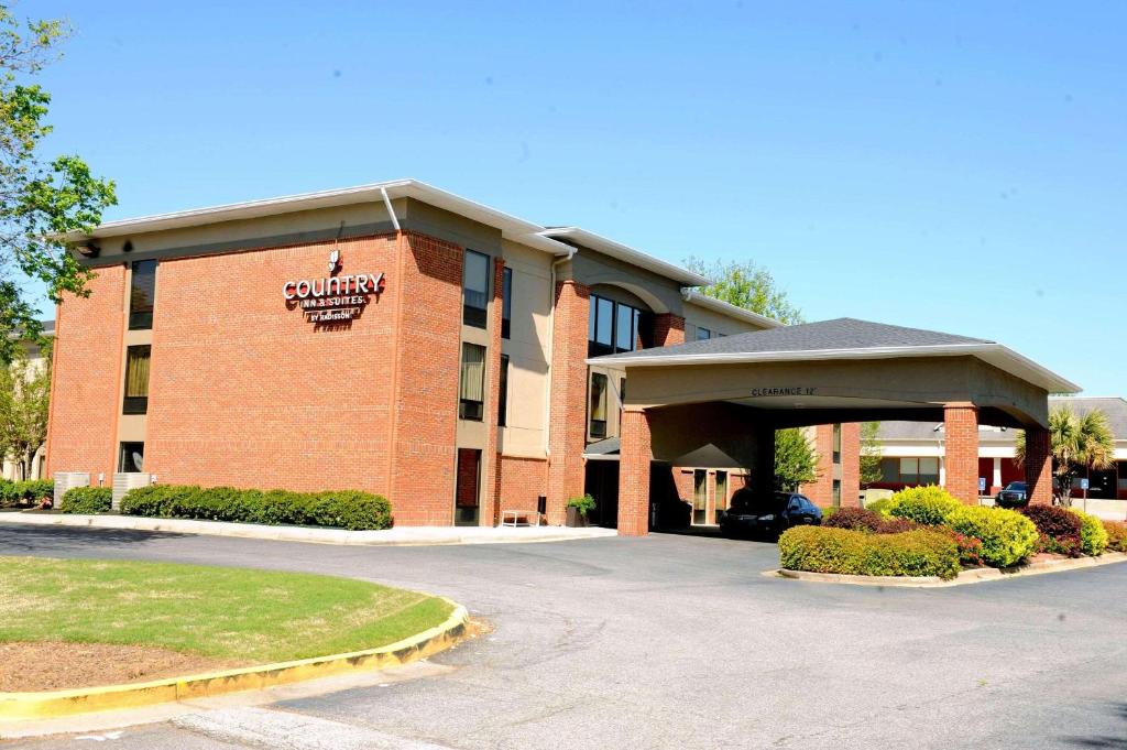 a building with a parking lot in front of it at Country Inn & Suites by Radisson, Alpharetta, GA in Alpharetta