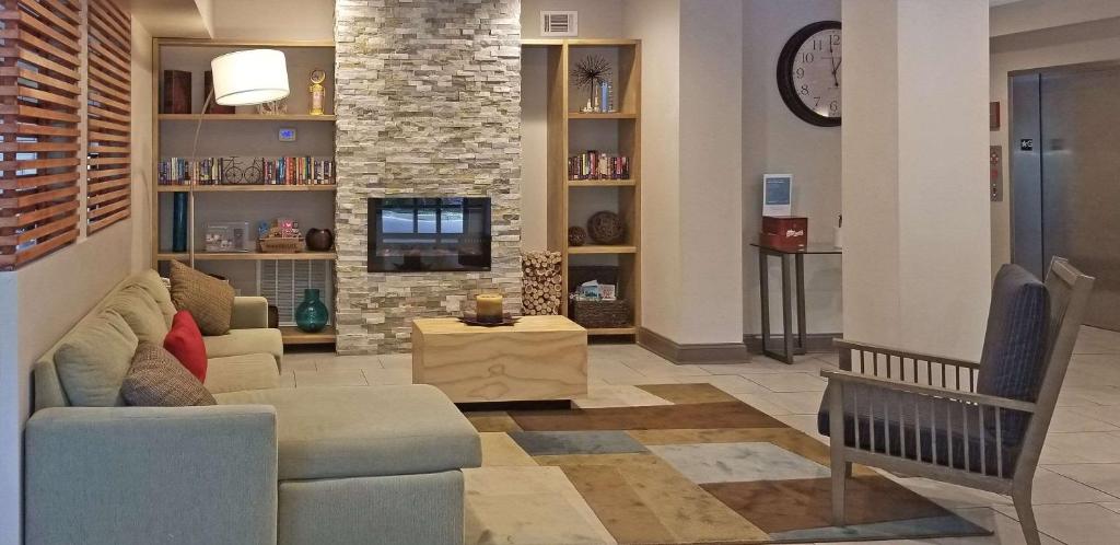 a living room with a couch and a tv at Country Inn & Suites by Radisson, Canton, GA in Canton