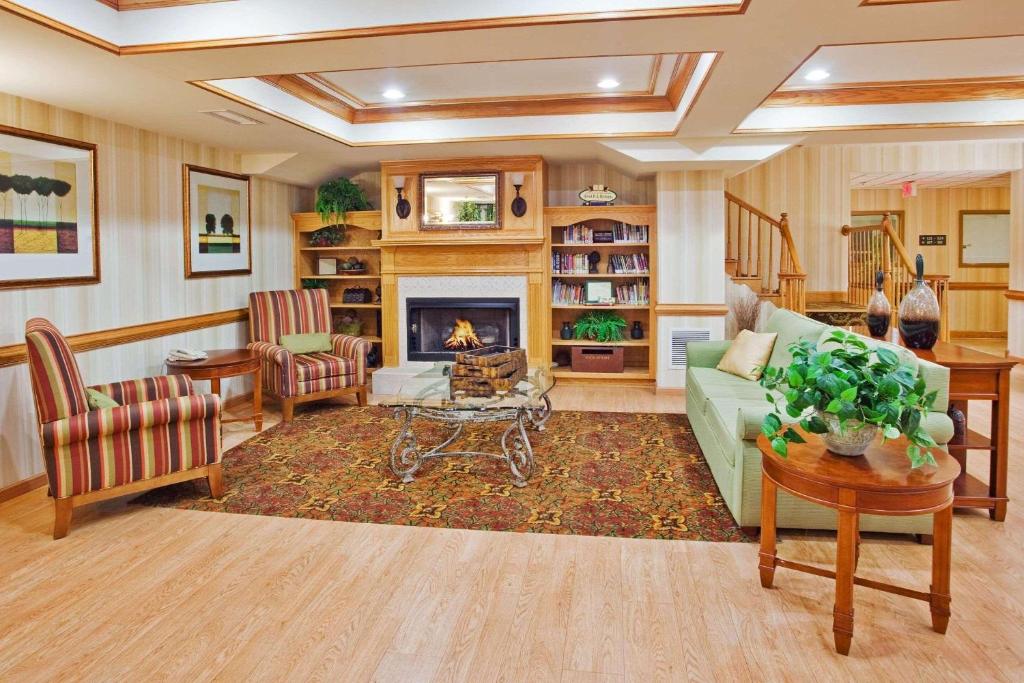 a living room with a couch and a fireplace at Country Inn & Suites by Radisson, McDonough, GA in McDonough