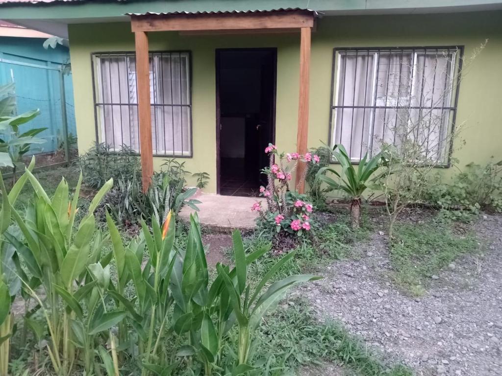 una casa con una puerta y flores delante de ella en Casa Astridainara, en Puerto Jiménez