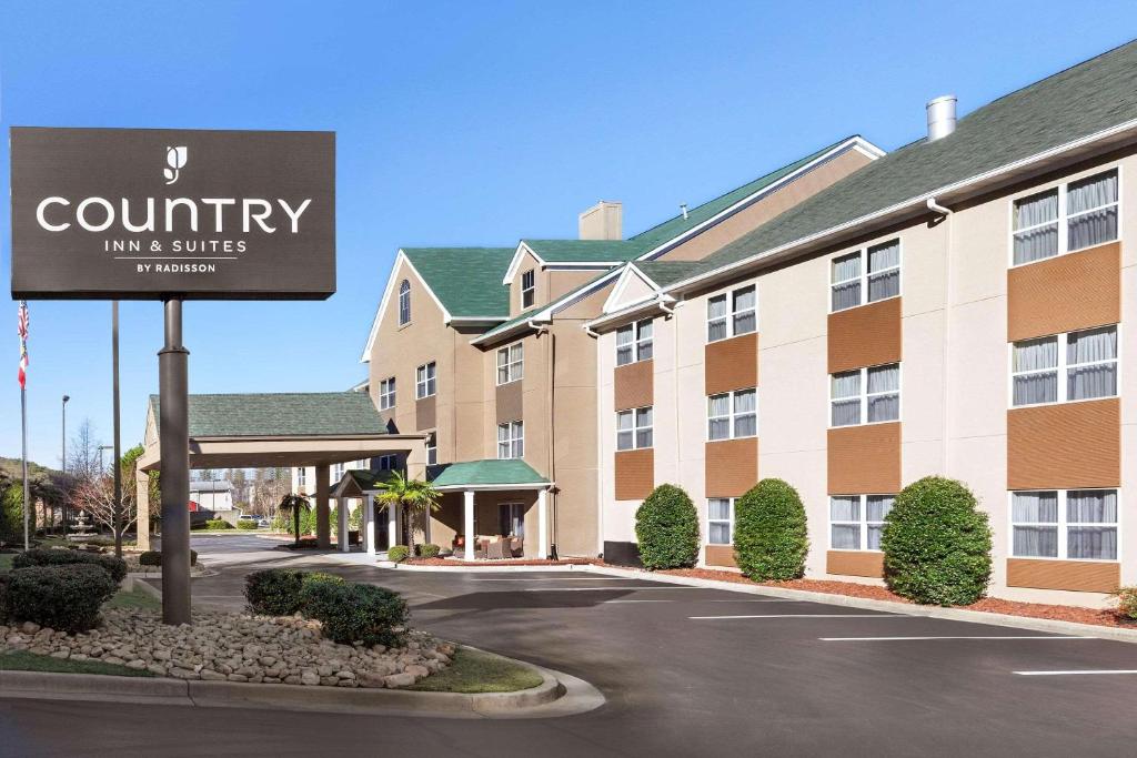 a building with a sign for a courtyard inn and suites at Country Inn & Suites by Radisson, Dalton, GA in Dalton