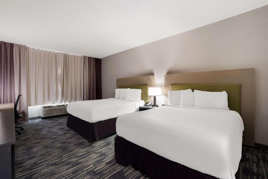 a hotel room with two beds and a window at Country Inn & Suites by Radisson, Augusta at I-20, GA in Augusta