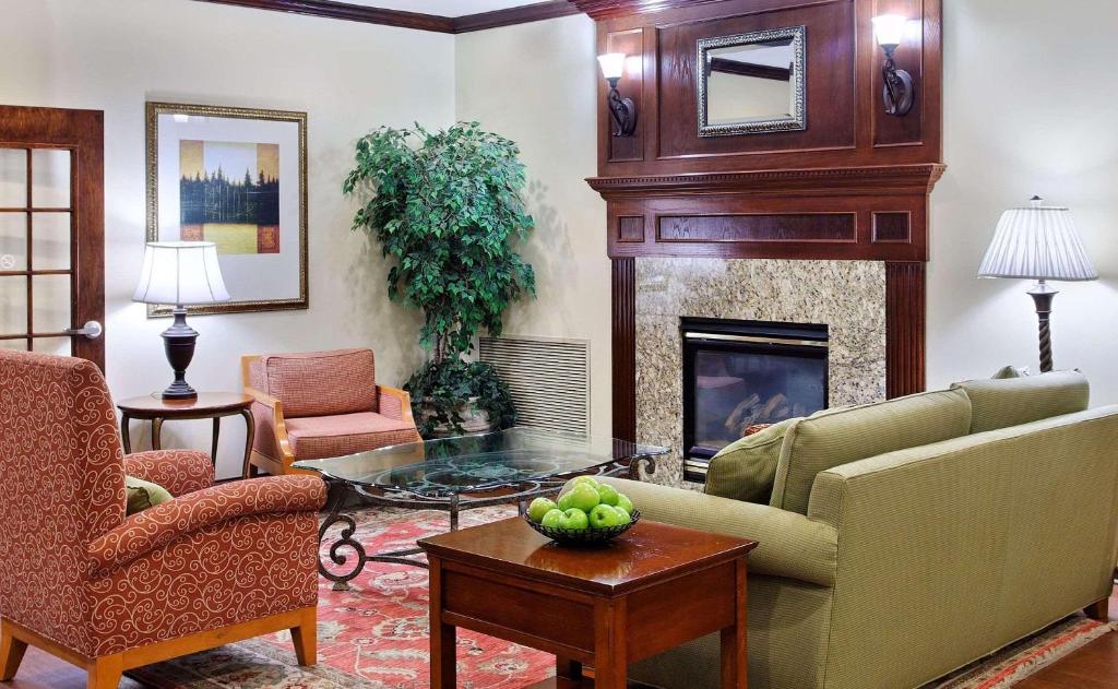 a living room with a couch and a fireplace at Country Inn & Suites by Radisson, Elgin, IL in Elgin