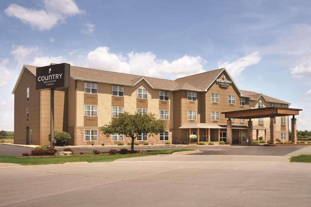 a large building with a sign for a campus at Country Inn & Suites by Radisson, Moline Airport, IL in Moline