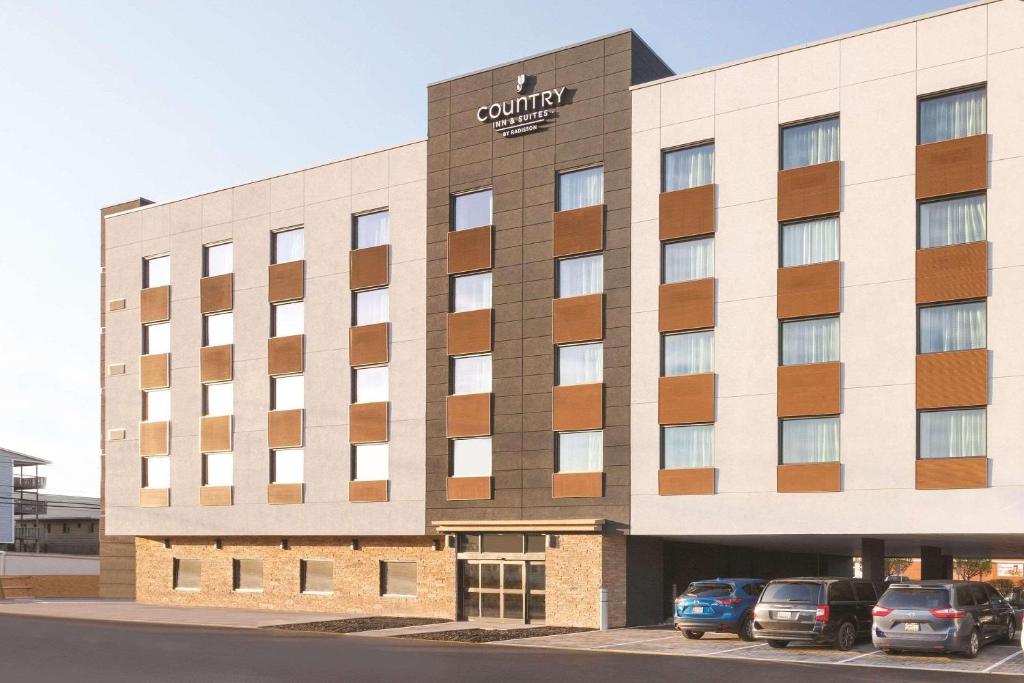 a building with cars parked in a parking lot at Country Inn & Suites by Radisson Ocean City in Ocean City